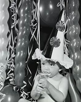 Beginnings Prints: Close-up of a baby boy sipping champagne from a glass