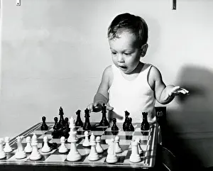 One Child Only Prints: Close-up of a boy playing chess