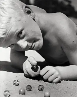 Facial Expression Prints: Close-up of a boy playing marbles