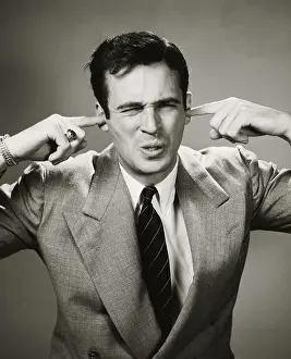 Business Suit Prints: Close-up of a businessman closing his ears with his fingers