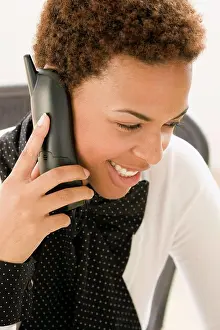 On The Phone Prints: Close-up of a businesswoman talking on a cordless phone and smiling