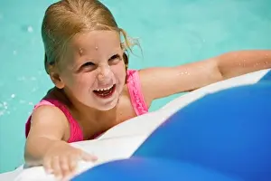 One Child Only Prints: Close-up of a cheerful girl looking up at swimming pool