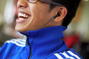 Jul06 Prints: Close-up of a college student wearing headphones and listening to music