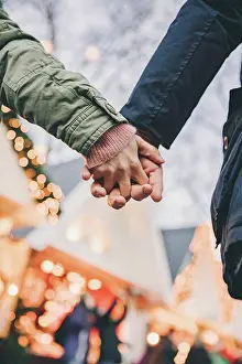 Lighted Prints: Close-up of couple holding hands on the Christmas Market