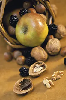 Colored Background Prints: Close-up of fruits and nuts spilling from a basket
