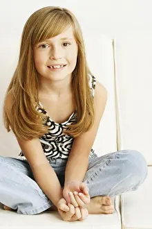 One Child Only Prints: Close-up of a girl sitting on a couch
