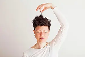 Whitebackground Prints: Close-up of happy mid adult woman holding her hair against white background