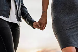 Associate Prints: Close-up of lesbian couple holding hands outdoors
