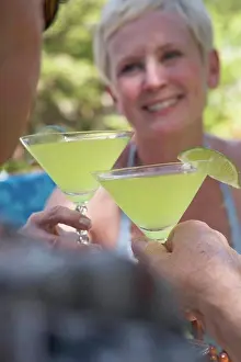 Jul06 Prints: Close-up of a mature couple toasting with martini glasses