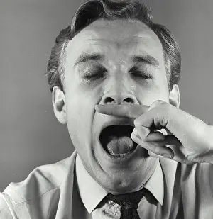 50 55 Years Prints: Close-up of a mature man sneezing