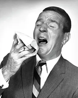 Shirt And Tie Prints: Close-up of a mature man sneezing