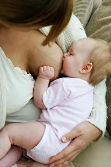 Beginnings Prints: Close-up of a mid adult woman breastfeeding her daughter