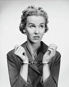Social Issues Prints: Close-up of a mid adult woman wearing handcuffs