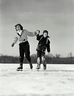 Skate Prints: Close-up of a mother ice skating with her son