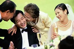 Beginnings Prints: Close-up of a mother kissing the groom