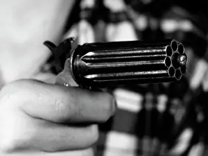 Antiquities Prints: Close-up of a person's hand holding a handgun, 22 Caliber Rupertus Derringer, 1860