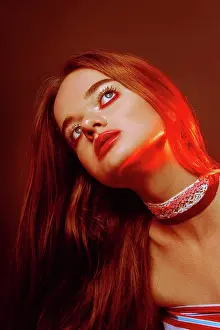 Foundation Prints: Close-up portrait of beautiful red-haired green-eyed girl with dark trendy makeup: red lips and red eyeshadows
