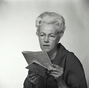 Envelope Prints: Close-up of a senior woman reading a letter