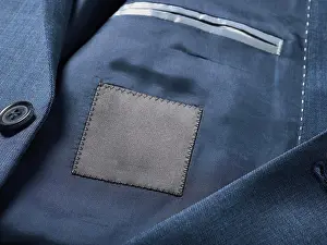 Smart Prints: Close-up of a tailored blue suit jacket with a black fabric patch inside