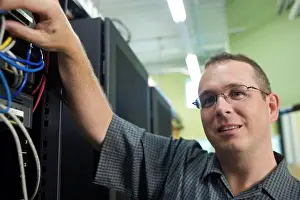 Technician Prints: Close-up of a technician checking cables of a computer network