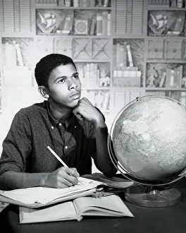 Globe Prints: Close-up of a teenage boy sitting at the table and thinking