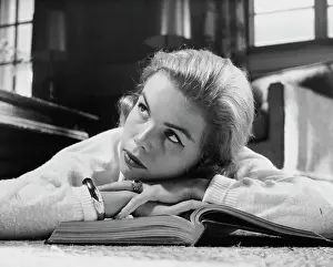 Sweater Prints: Close-up of a teenage girl lying on a book and thinking