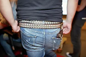 Casual Wear Prints: A close-up view of a person wearing blue denim jeans and a black shirt tucked