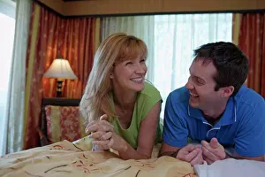 Shade Prints: Close-up of a young couple lying on the bed and smiling