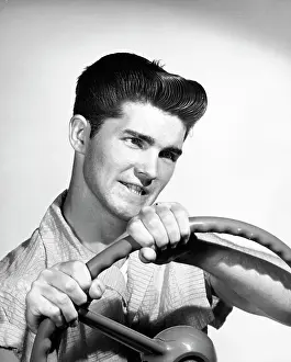 Gripping Prints: Close-up of a young man holding a steering wheel