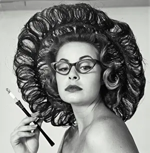 Smoking Prints: Close-up of a young woman holding a cigarette holder