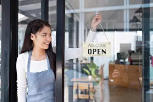 Cafeteria Prints: Close up of woman'™ hands holding sign now we are open support