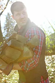 Gloves Prints: Collecting wood, deforestation and lumberjack man in forest for industry