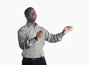 Instrument Prints: A college age man holds a baton and conducts