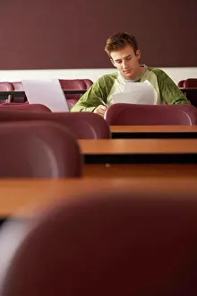 Purestock Prints: College student sitting in a lecture hall and studying