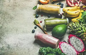 Copyspace Prints: Colorful smoothies in bottles with fresh tropical fruit and superfood on grey concrete background