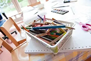 Group Of Objects Prints: Coloured pencils in a basket on a table, elevated view