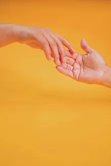 Ecuador Prints: Concept of mother and daughter hands outstretched to get in touch