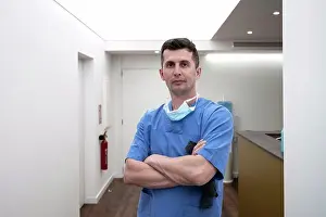Physician Prints: Confident male surgeon standing with arms crossed at hospital