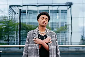 Apparel Prints: Confident young African American male teenager model in trendy tartan coat