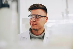 Instruction Prints: Confident young chemistry student wearing eyewear looking away in laboratory
