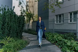 Pathway Prints: Confident young woman enjoying a walk in an urban neighborhood