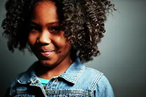 Soft Focus Prints: Confident youth in denim jacket with a subtle smile