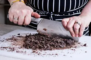 Ingredient Prints: A cook chopping chocolate pieces with a large cleaver