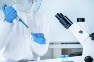Analysis Prints: Coronavirus vaccine research, scientist working in the laboratory, holding a micropipette