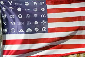 Corporate Prints: Corporate logos in place of stars on the American flag symbolize allegiance to and dominance of Corporate America