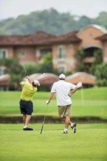 Skilled Prints: Costa Rica, Two Golfers teeing off over water
