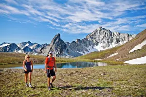 Hike Prints: couple backpacking in scenic alpine meadow, mountains behind