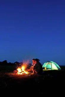 Tent Prints: Couple camping with fire outside tent in field