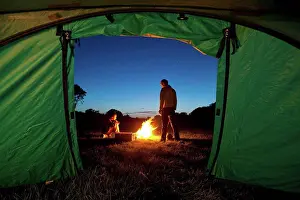 Tent Prints: Couple camping with fire outside tent in field