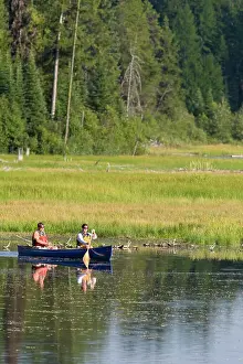 Couple canoeing on Upper Stillwater Lake in Montana (MR)